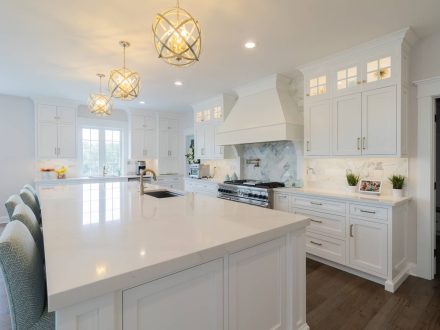 Large white kitchen with island after renovation